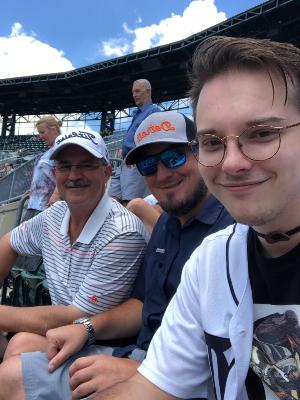 Dave (left) and his sons at a baseball game.